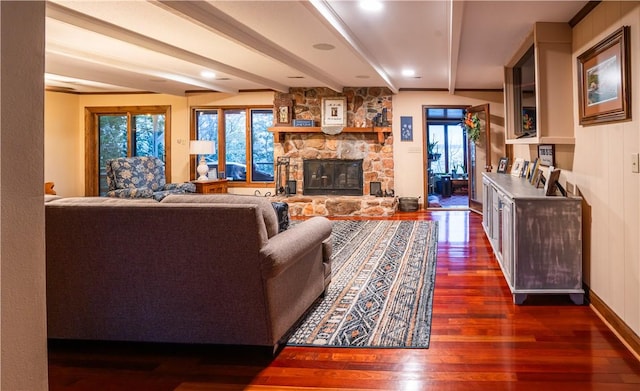 living room with a fireplace, dark wood-type flooring, and beamed ceiling