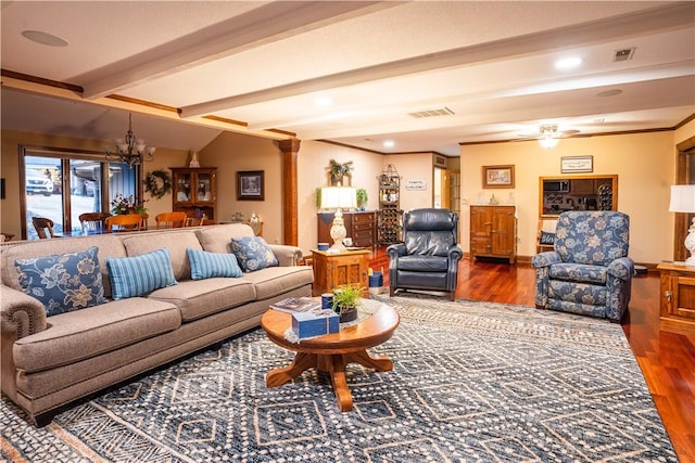 living room featuring hardwood / wood-style flooring, a notable chandelier, decorative columns, and lofted ceiling with beams