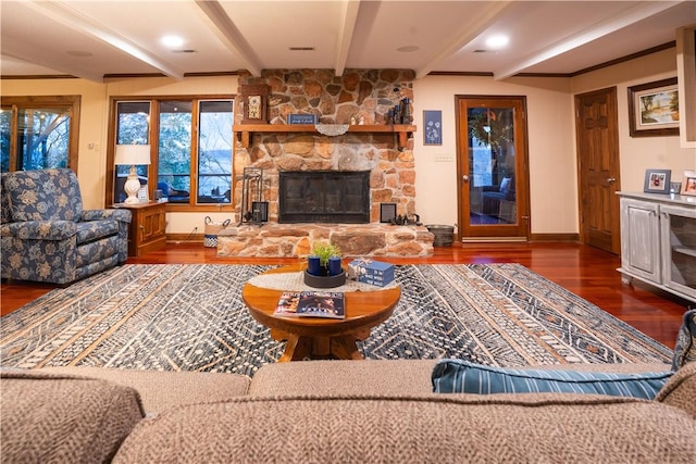 living room with dark wood-type flooring, a stone fireplace, and beamed ceiling