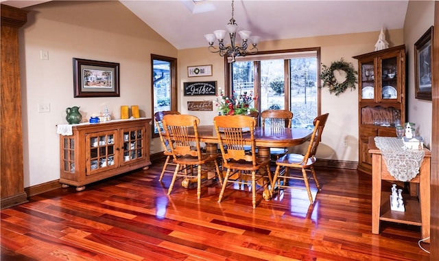 dining area featuring lofted ceiling, dark hardwood / wood-style flooring, and a notable chandelier