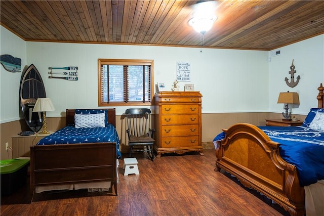 bedroom featuring ornamental molding, dark hardwood / wood-style floors, and wooden ceiling