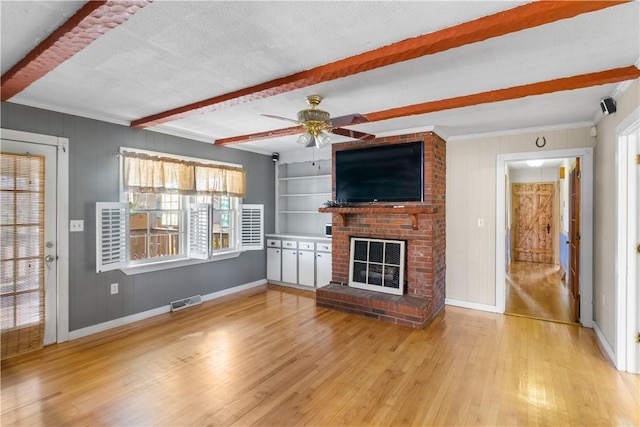 109 Pine Tree Ln, Anderson, SC 29625 - unfurnished living room with built in features, a fireplace, beamed ceiling, a textured ceiling, and light hardwood / wood-style flooring
