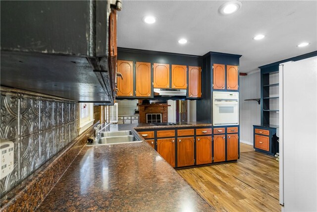 109 Pine Tree Ln, Anderson, SC 29625 - kitchen with sink, light wood-type flooring, kitchen peninsula, black electric stovetop, and white oven