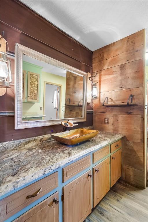 109 Pine Tree Ln, Anderson, SC 29625 - bathroom featuring vanity, wood-type flooring, and wood walls