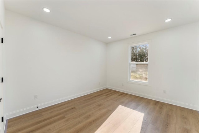 empty room with light hardwood / wood-style flooring