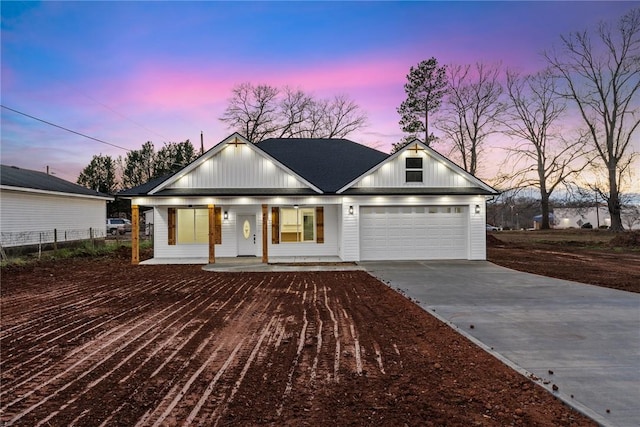 view of front of property with a porch and a garage