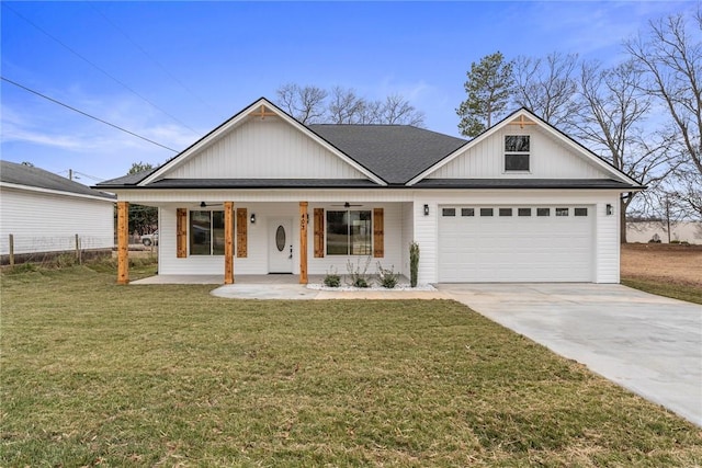 view of front of property featuring a porch, a garage, and a front yard