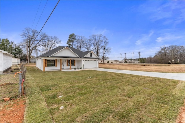 view of front of home with a porch, a garage, and a front yard