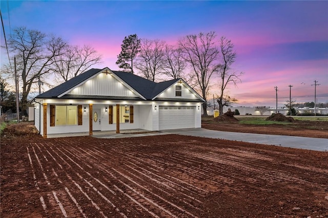 view of front of home with a porch and a garage