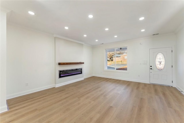 unfurnished living room featuring crown molding and light wood-type flooring