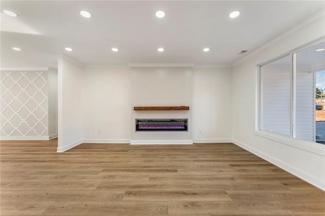 unfurnished living room featuring crown molding and light wood-type flooring