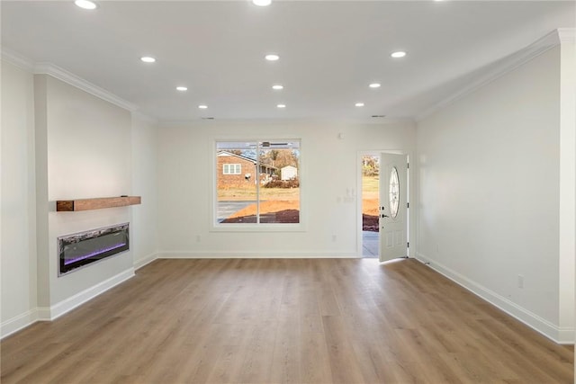 unfurnished living room with crown molding and light hardwood / wood-style floors