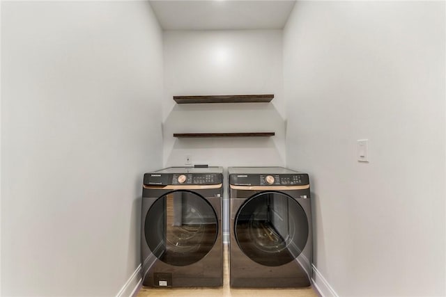 clothes washing area with washer and clothes dryer