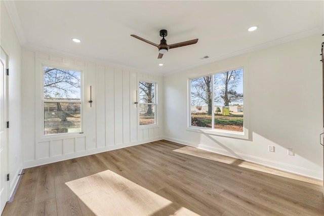 unfurnished room featuring ceiling fan, ornamental molding, and wood-type flooring