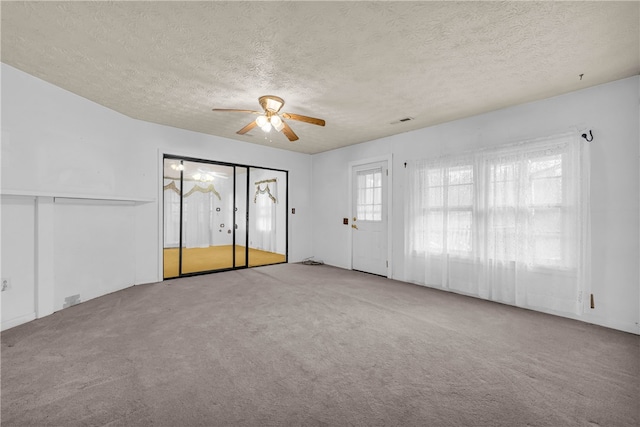 interior space with light carpet and a textured ceiling