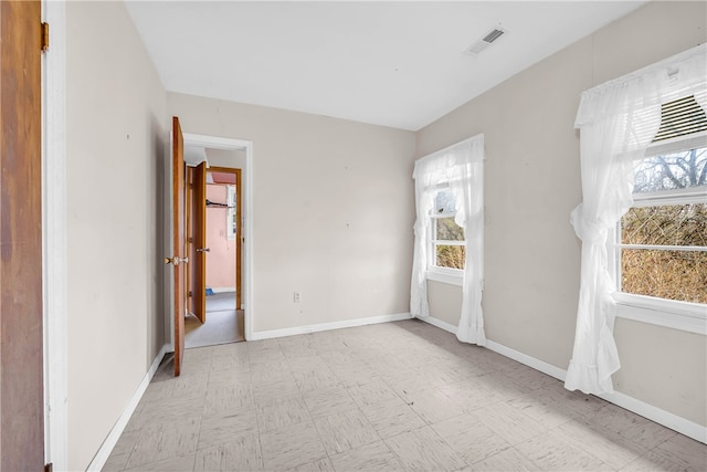 spare room featuring a wealth of natural light