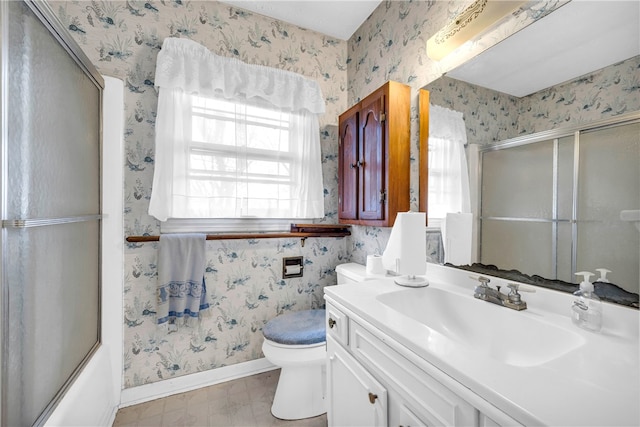 full bathroom featuring bath / shower combo with glass door, vanity, and toilet