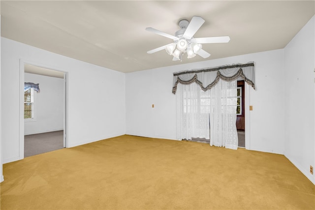 spare room featuring carpet flooring and ceiling fan