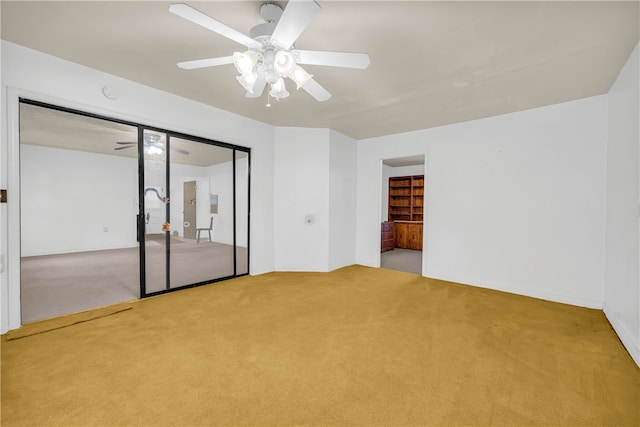 unfurnished bedroom with a closet, ceiling fan, and carpet flooring