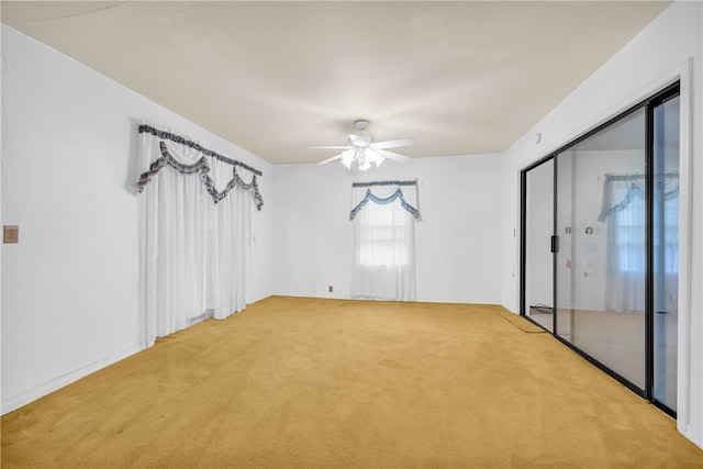 carpeted empty room featuring ceiling fan