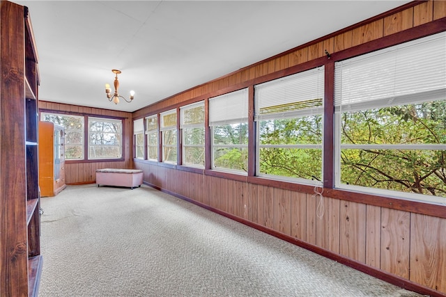 unfurnished sunroom with an inviting chandelier