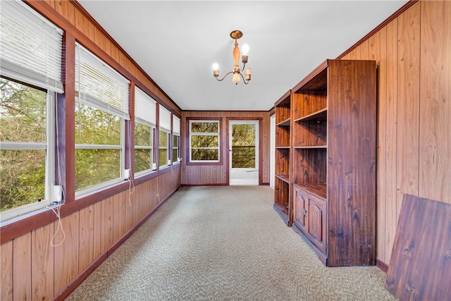 unfurnished sunroom with a chandelier