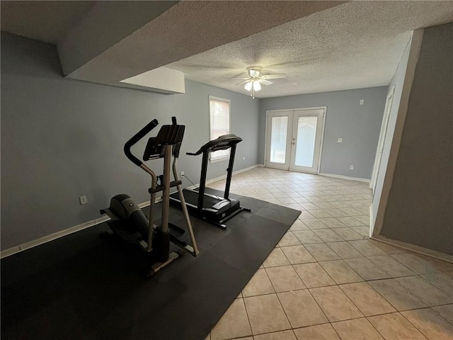 workout room with ceiling fan, french doors, a textured ceiling, and light tile patterned flooring