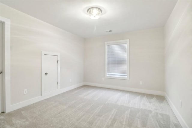 spare room with light colored carpet