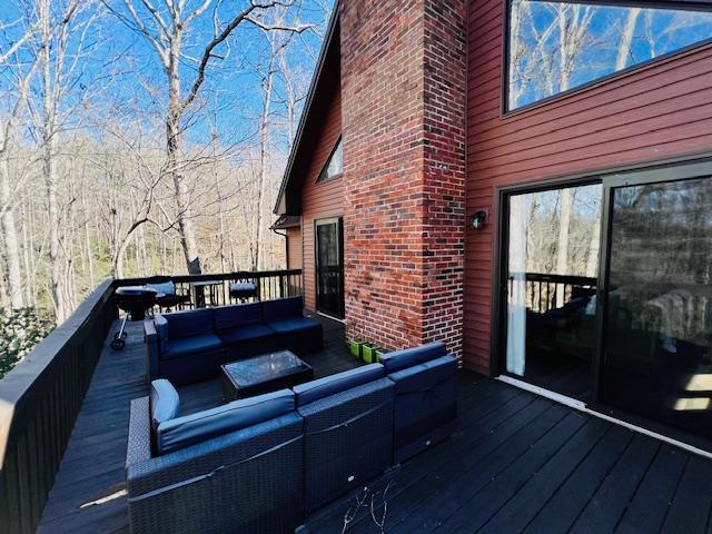 wooden terrace featuring an outdoor living space