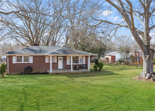 view of front of home featuring brick siding, a front lawn, roof with shingles, a chimney, and crawl space