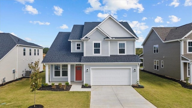 view of front of property with cooling unit, a garage, and a front yard