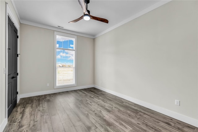 spare room with ornamental molding, ceiling fan, and light hardwood / wood-style floors