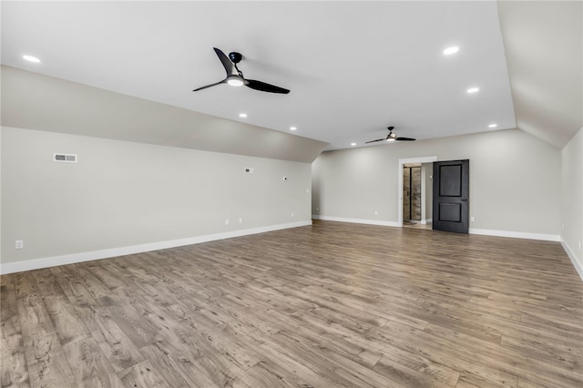 interior space featuring lofted ceiling, light hardwood / wood-style floors, and ceiling fan