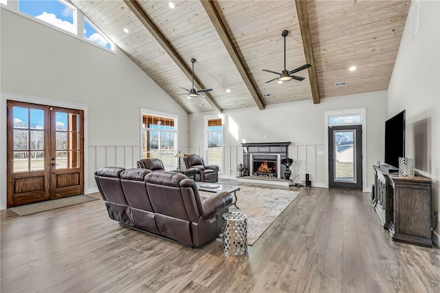 living room featuring french doors, wood ceiling, high vaulted ceiling, light hardwood / wood-style flooring, and beam ceiling