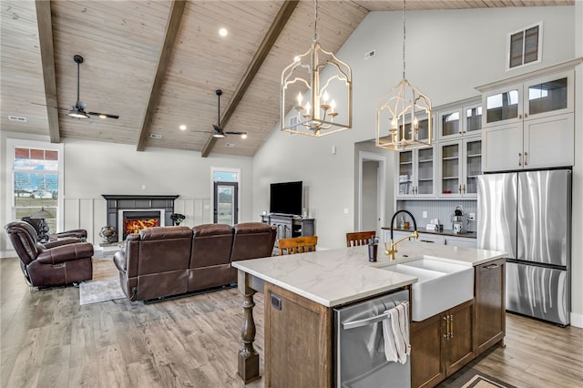 kitchen with white cabinetry, sink, a kitchen island with sink, wood ceiling, and stainless steel appliances