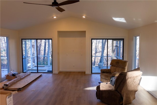 living room with hardwood / wood-style flooring, lofted ceiling, and ceiling fan