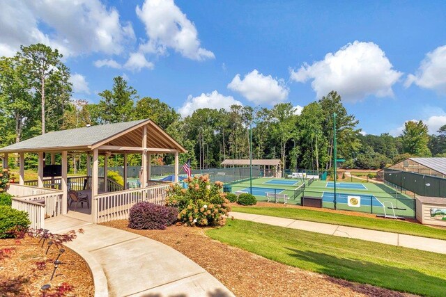 view of property's community featuring tennis court and a gazebo