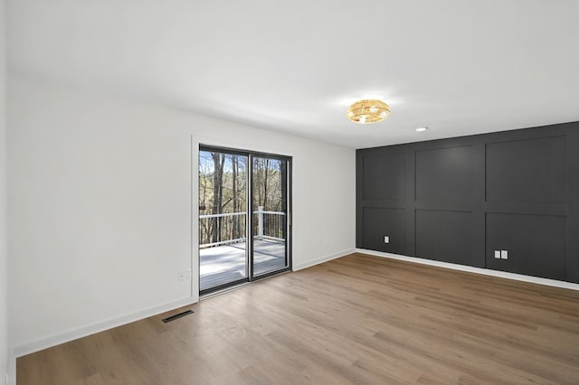 24 Mainsail Dr, Salem, SC 29676 - unfurnished bedroom featuring access to outside, a decorative wall, light wood-style floors, visible vents, and baseboards
