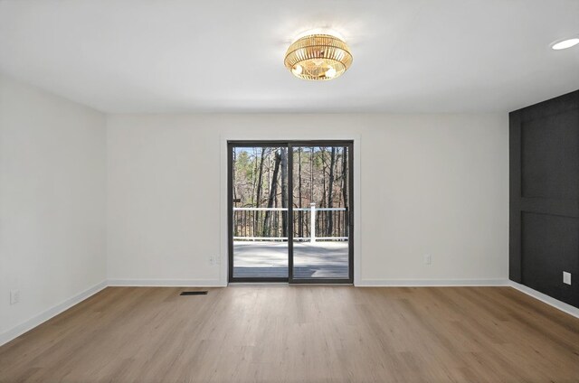 24 Mainsail Dr, Salem, SC 29676 - unfurnished room with baseboards, light wood finished floors, and a notable chandelier