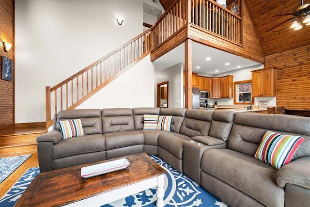 living room with sink, wood ceiling, hardwood / wood-style flooring, ceiling fan, and high vaulted ceiling