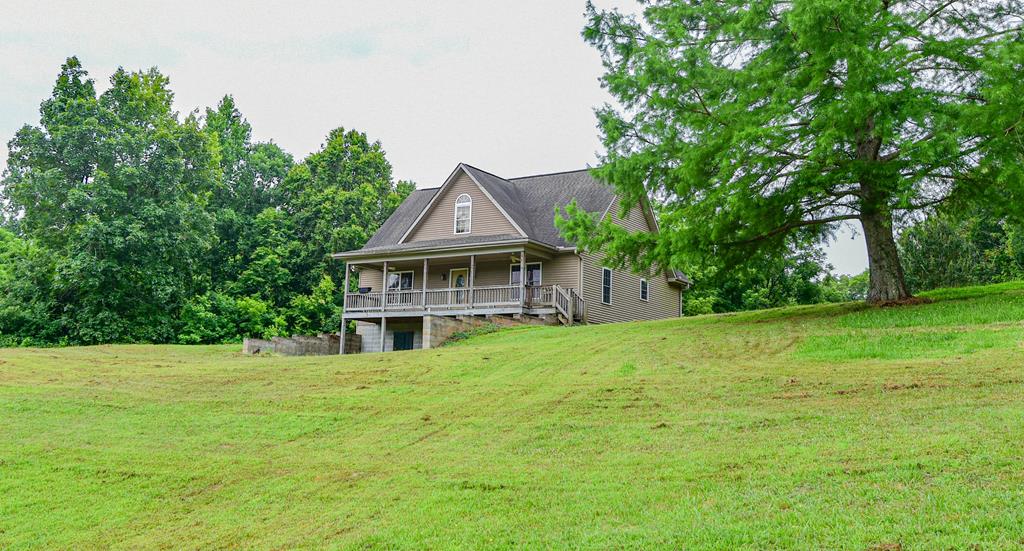 view of front of home featuring covered porch and a front yard