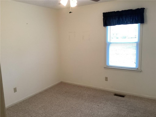 spare room featuring a healthy amount of sunlight and carpet