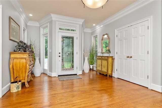 entrance foyer with crown molding and light hardwood / wood-style flooring