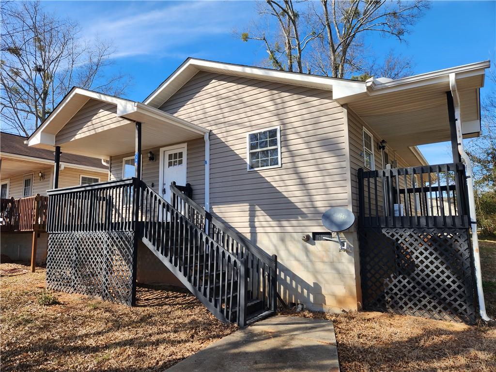 view of side of property with covered porch