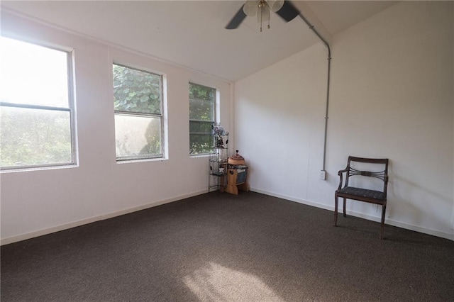 carpeted empty room featuring ceiling fan and vaulted ceiling