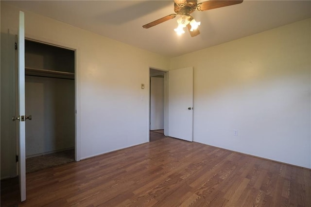 unfurnished bedroom featuring dark hardwood / wood-style flooring, a closet, and ceiling fan