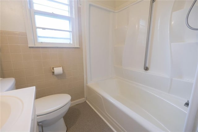 full bathroom with vanity, shower / bathing tub combination, tile walls, and toilet