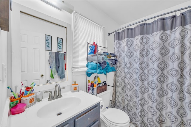 bathroom with a shower with curtain, vanity, and toilet