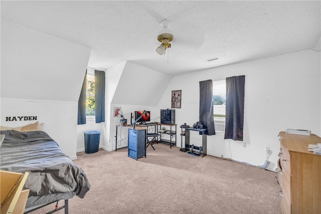 carpeted bedroom featuring multiple windows, lofted ceiling, a textured ceiling, and ceiling fan