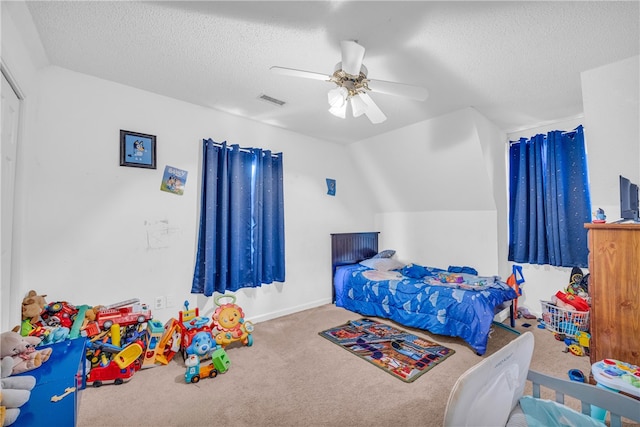 bedroom featuring a textured ceiling, vaulted ceiling, and ceiling fan